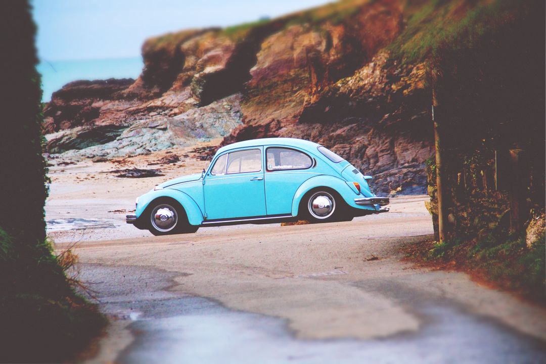 Vintage Blue Car Parked on Rocky Beach Shoreline - Free Images, Stock Photos and Pictures on Pikwizard.com