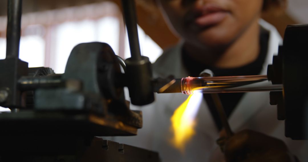 Close-Up of Female Glass Blower Using Heat in Factory Workshop