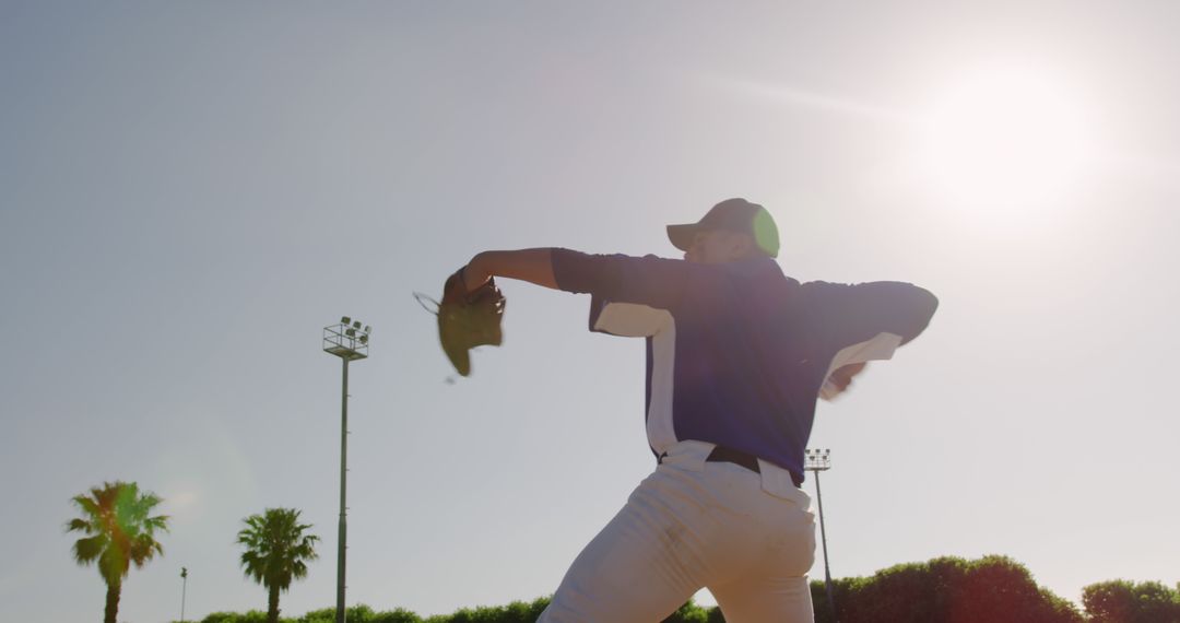 Baseball Pitcher Throwing Ball under Sunny Sky at Outdoor Ballpark - Free Images, Stock Photos and Pictures on Pikwizard.com