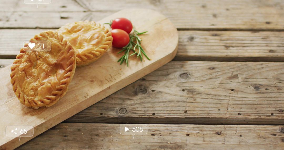 Rustic Hand Pies Sitting on Wooden Board with Cherry Tomatoes and Rosemary