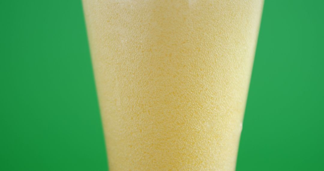 Closeup of Refreshing Cold Beer Foam Against Green Background - Free Images, Stock Photos and Pictures on Pikwizard.com