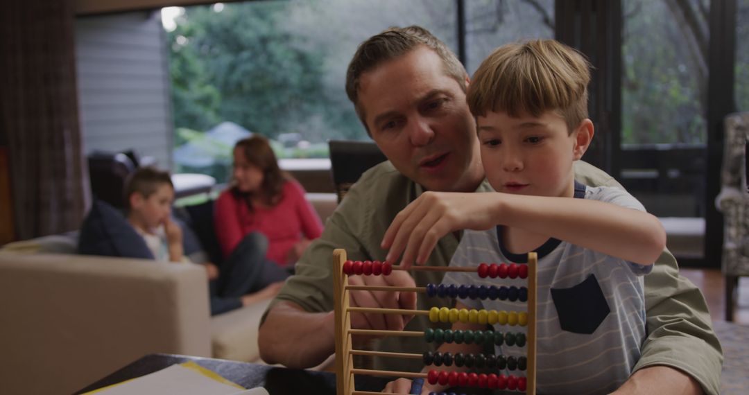 Father Teaching Son with Abacus at Home - Free Images, Stock Photos and Pictures on Pikwizard.com