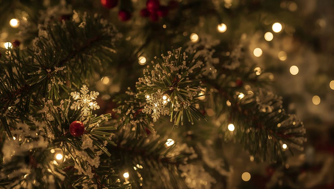 Frosted Pine Close-Up Showing Crystal Snowflake Ornament, Red Berries and Warm Bokeh Lights