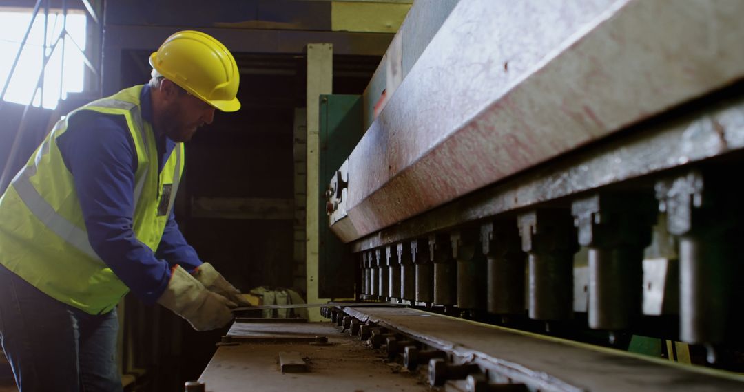 Worker Oversees Operation of Industrial Machine with Precision - Free Images, Stock Photos and Pictures on Pikwizard.com