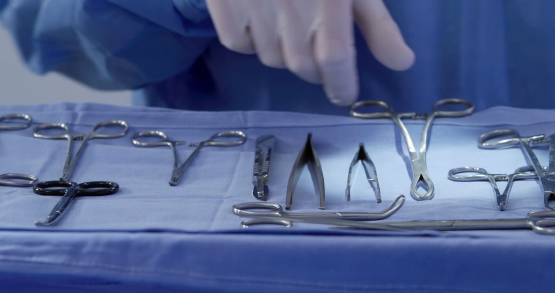 Surgeon Arranging Surgical Instruments on Sterile Tray in Operating Room - Free Images, Stock Photos and Pictures on Pikwizard.com