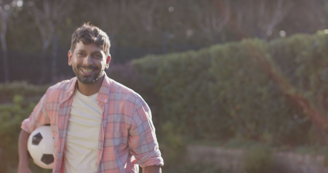 Active Indian Man Enjoying Sunny Day with Soccer Ball