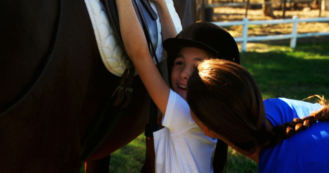 Parent Helping Child Prepare for Horseback Riding - Free Images, Stock Photos and Pictures on Pikwizard.com