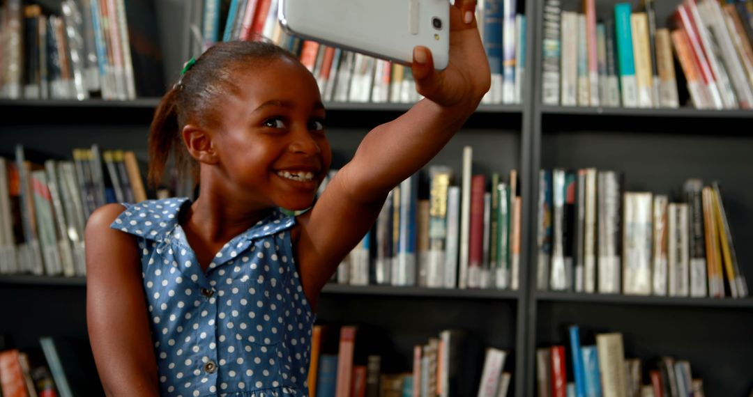 Joyful Girl Taking a Selfie in Library With Gratifying Smile - Free Images, Stock Photos and Pictures on Pikwizard.com