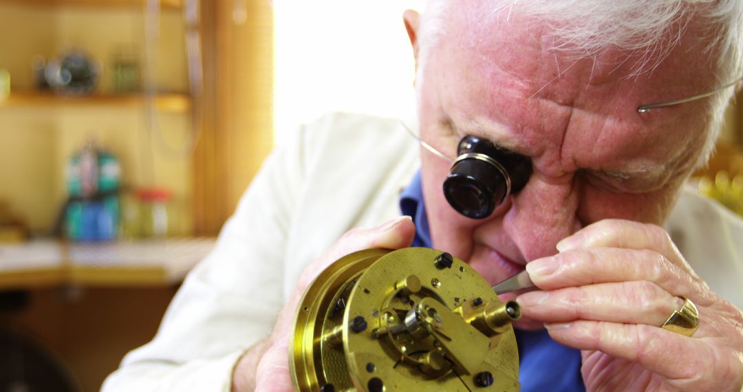 Elderly Watchmaker Focusing on Intricate Mechanism in Workshop - Free Images, Stock Photos and Pictures on Pikwizard.com