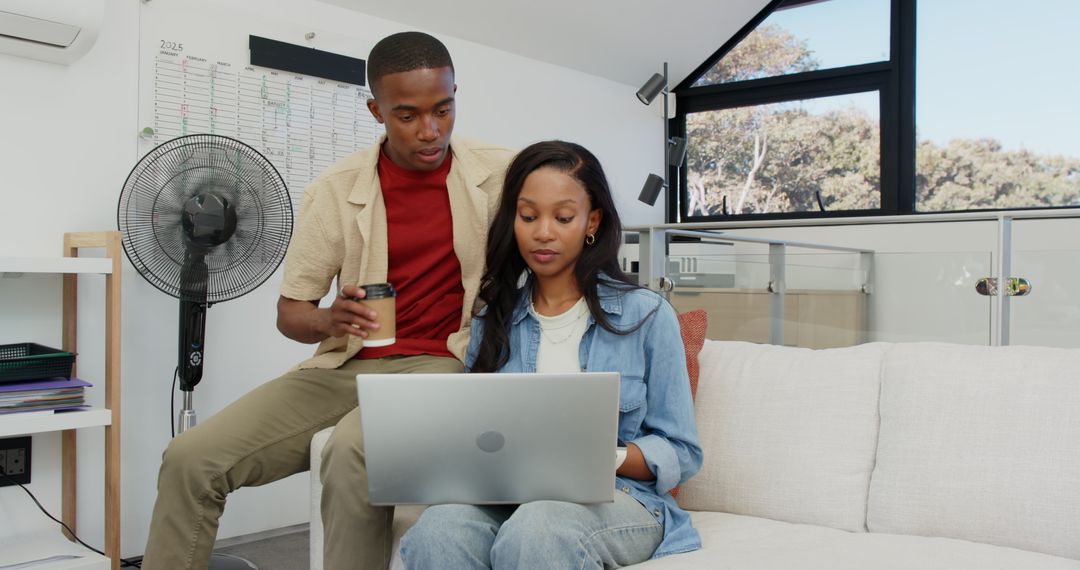 Colleagues Collaborating in Modern Loft Office with Laptop