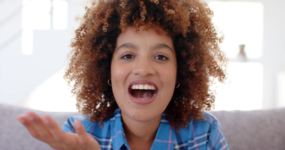 Joyful Woman with Curly Hair Smiling Indoors - Free Images, Stock Photos and Pictures on Pikwizard.com