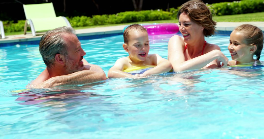 Happy Family Enjoying Swimming Pool Time Together - Free Images, Stock Photos and Pictures on Pikwizard.com