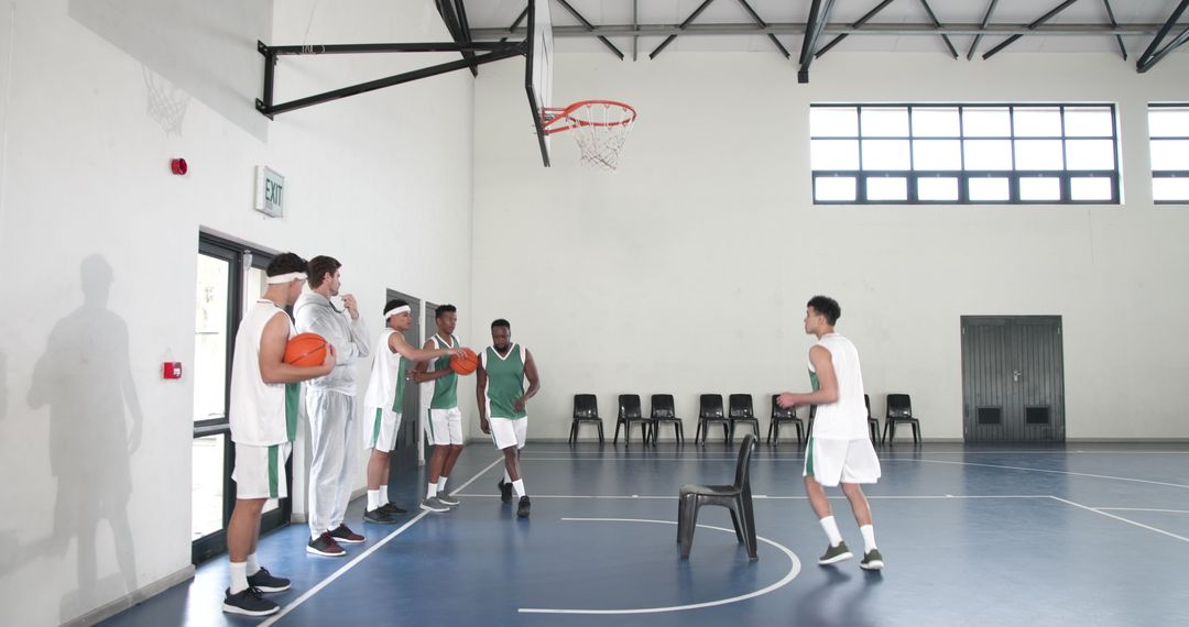 Diverse Basketball Team Practicing on Indoor Court