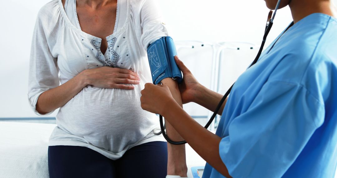 Pregnant Women Getting Blood Pressure Tested by Healthcare Worker - Free Images, Stock Photos and Pictures on Pikwizard.com