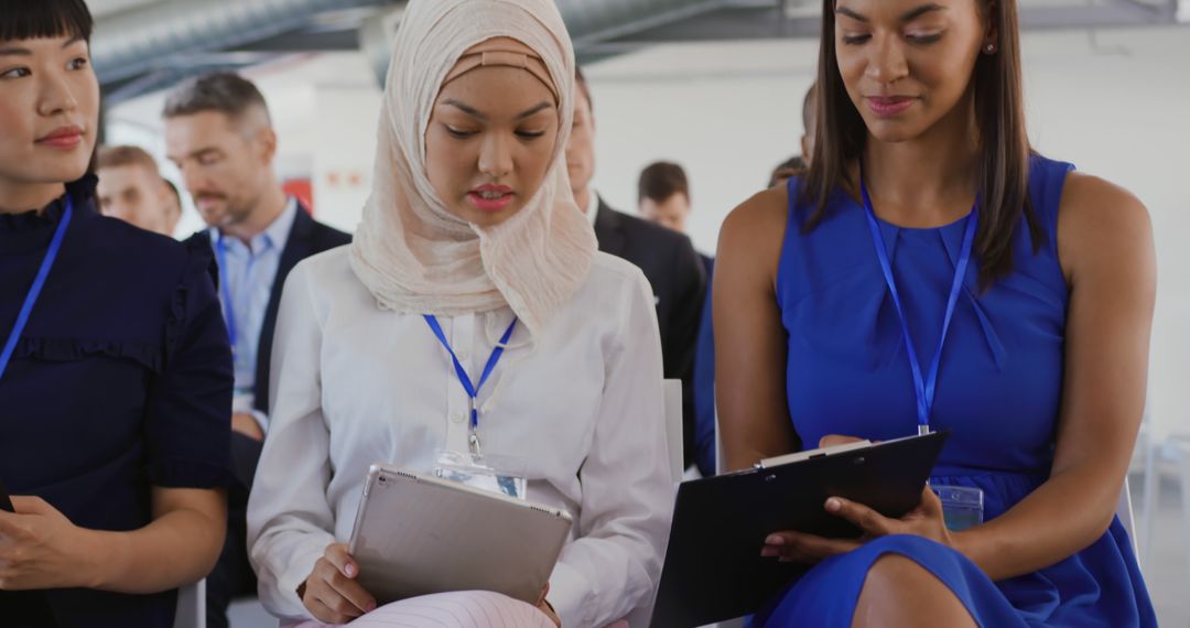 Diverse Businesswomen Engaged at Seminar with Technology