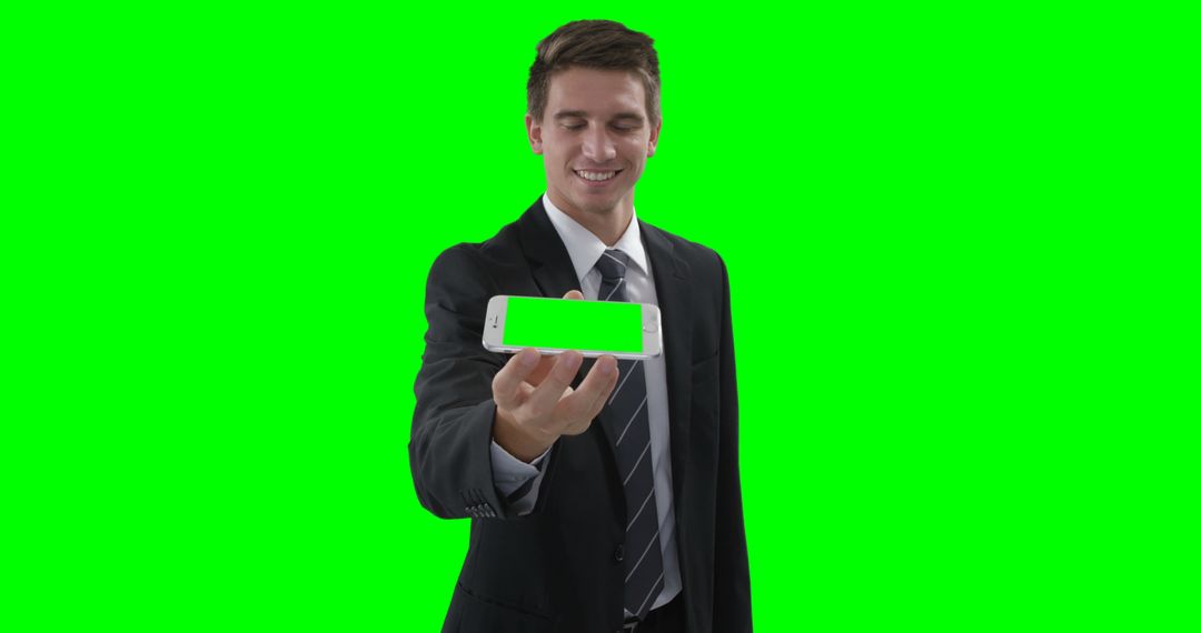 Businessman Smiling While Showing Smartphone with Green Screen - Free Images, Stock Photos and Pictures on Pikwizard.com