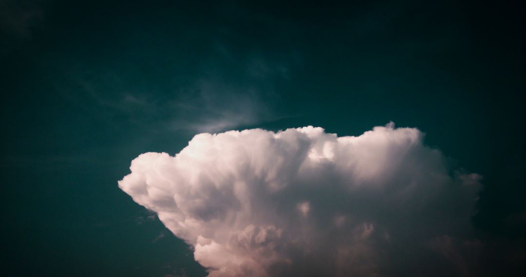 Dramatic Cumulonimbus Cloud with Dark Turquoise Skybackdrop