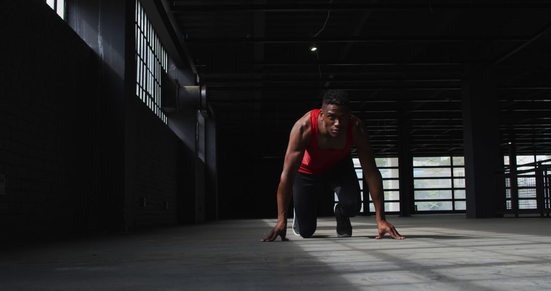 Determined African American Man Preparing for Running Start Indoors - Free Images, Stock Photos and Pictures on Pikwizard.com