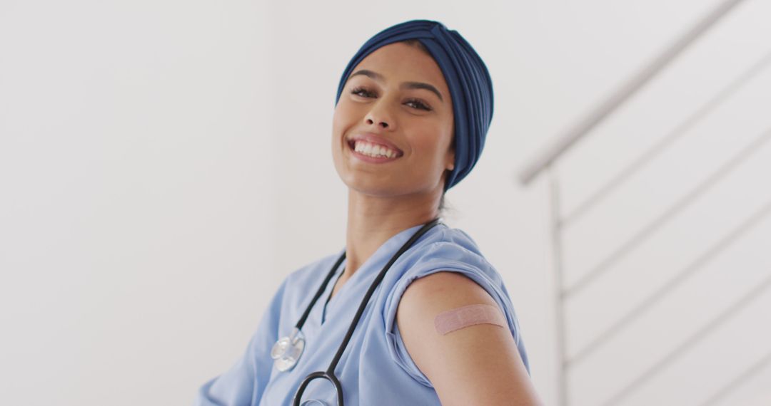 Smiling Nurse Showing Bandage After Vaccination - Free Images, Stock Photos and Pictures on Pikwizard.com