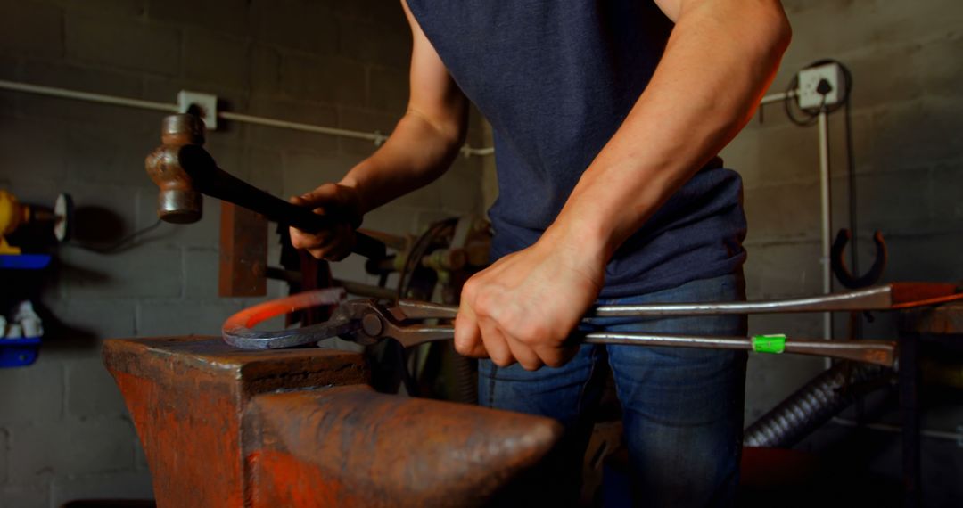 Blacksmith Shaping Glowing Metal with Hammer - Free Images, Stock Photos and Pictures on Pikwizard.com