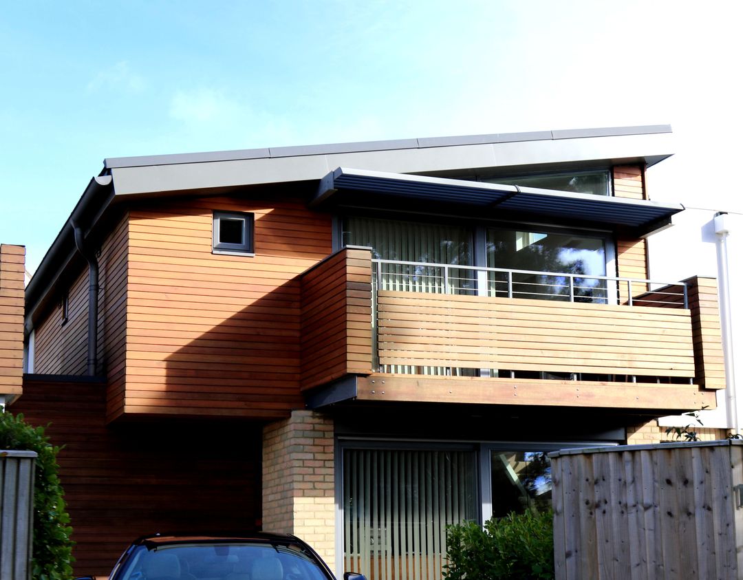 Modern Cubic Wooden House with Overhanging Balcony Design