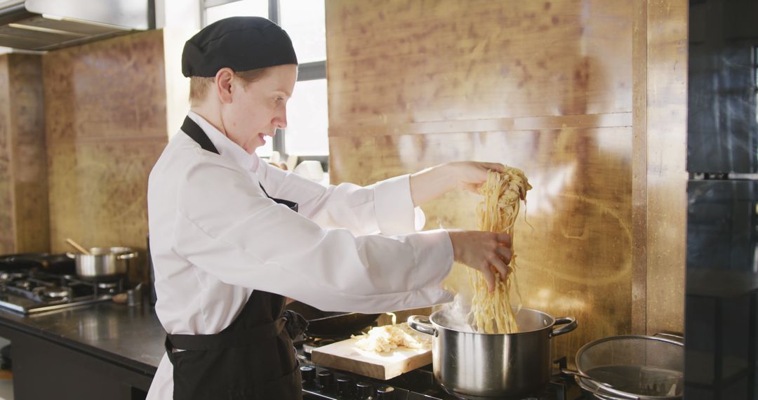 Professional Chef Preparing Pasta in Commercial Kitchen - Free Images, Stock Photos and Pictures on Pikwizard.com