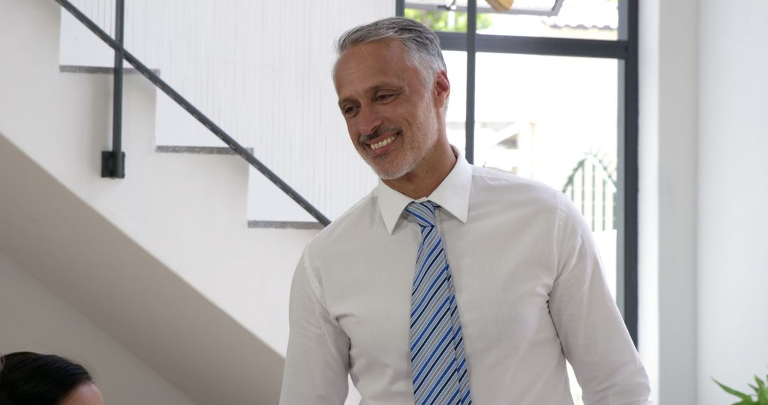 Confident Businessman in Shirt and Tie Smiling in Modern Office - Free Images, Stock Photos and Pictures on Pikwizard.com