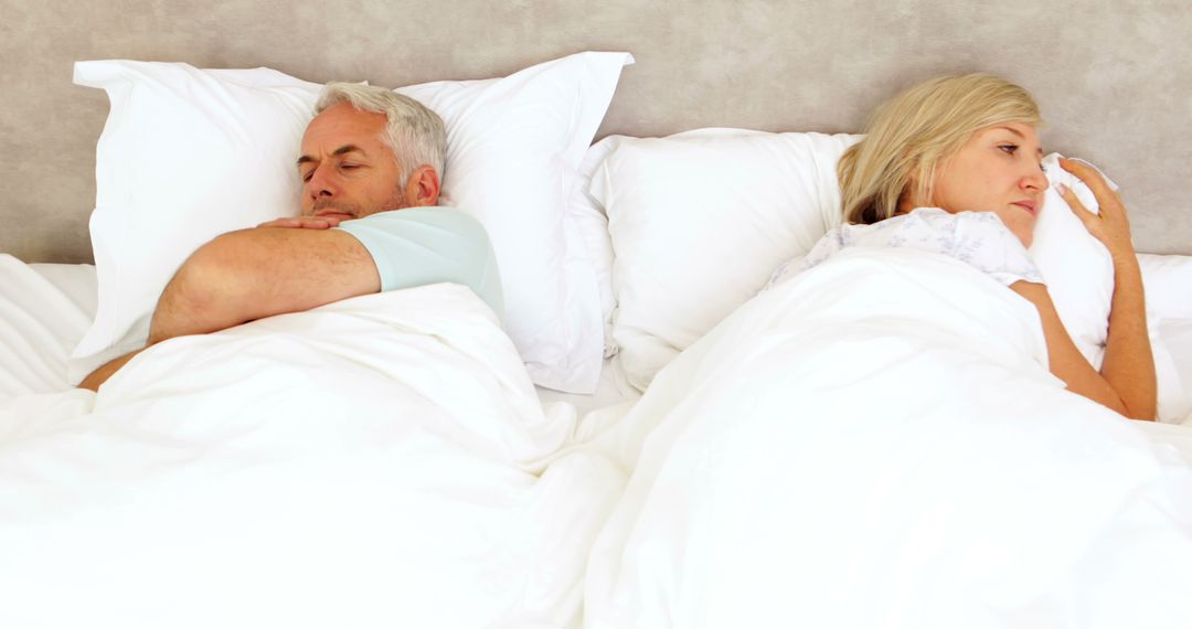 Unhappy Senior Couple Ignoring Each Other in Bed