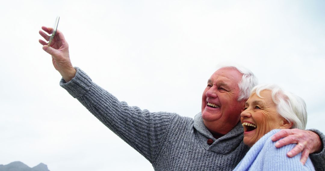 Senior Couple Smiling and Taking a Selfie Outdoors - Free Images, Stock Photos and Pictures on Pikwizard.com