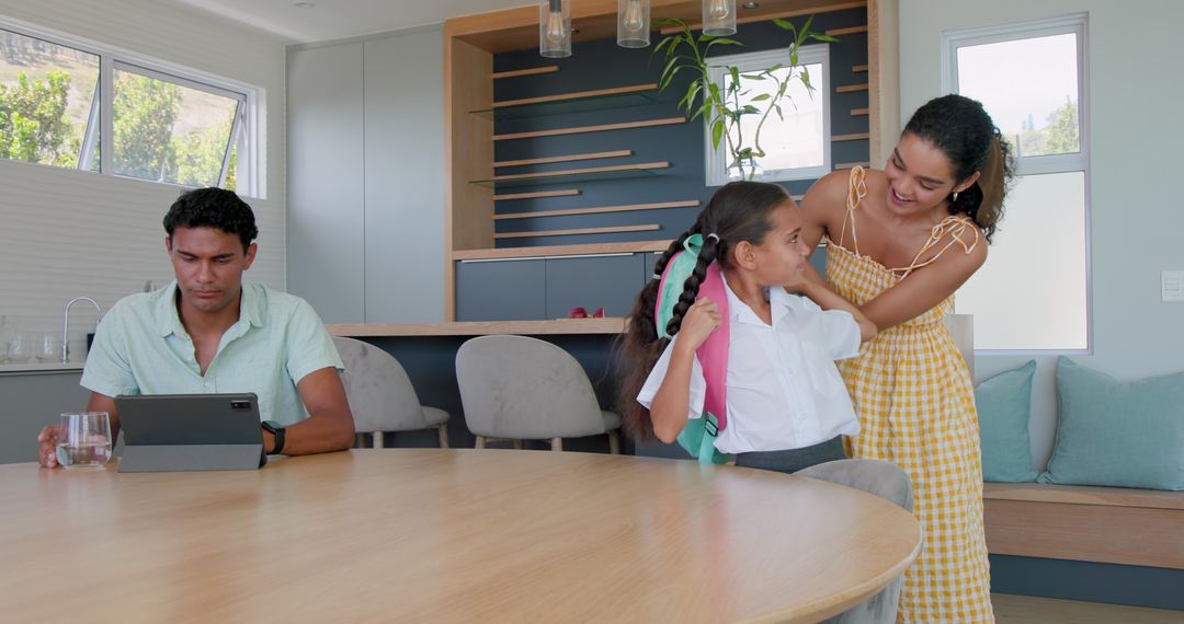 Morning Routine: Mother Assisting Daughter for School While Father Works