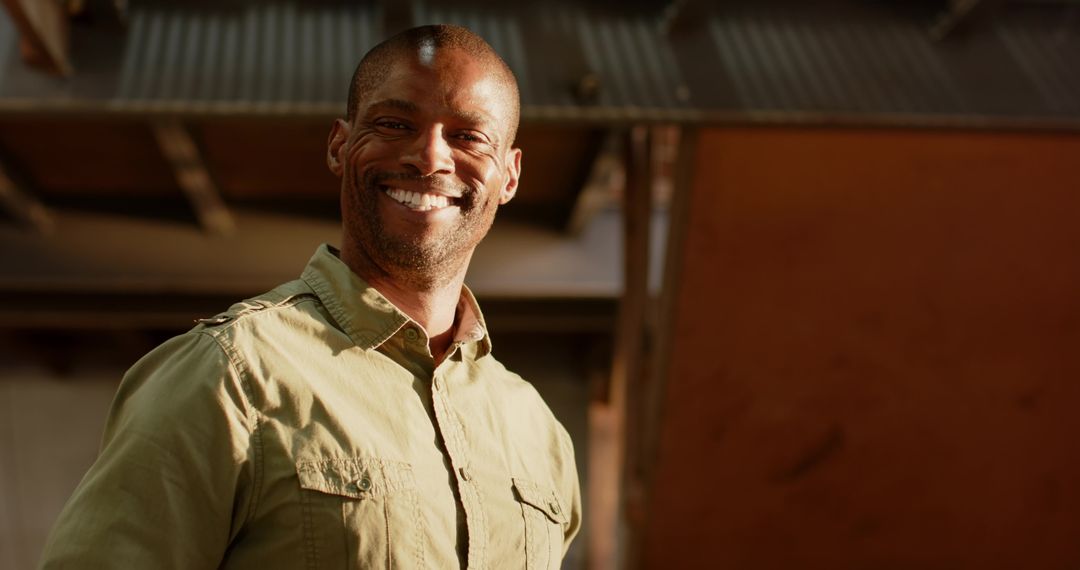 Confident Worker in Industrial Setting with Corrugated Roof