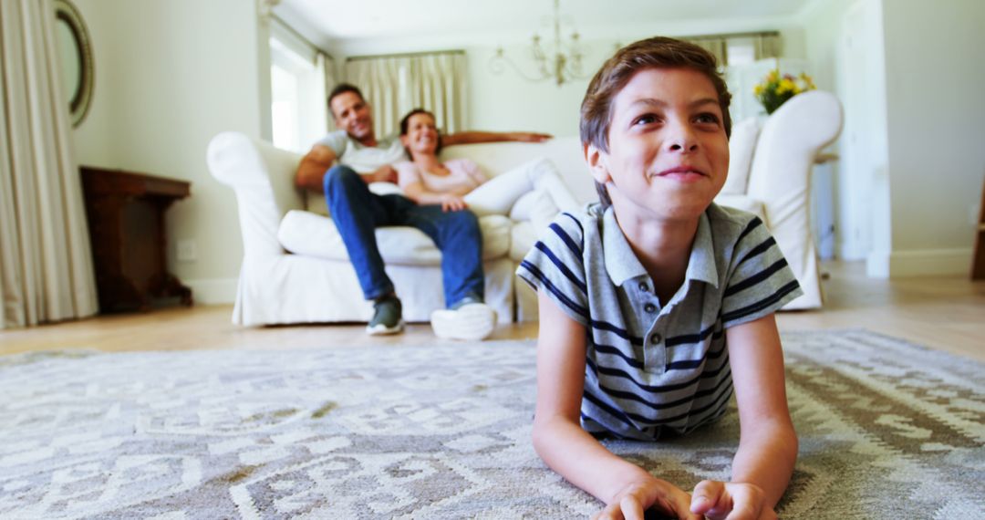 Smiling Boy with Family Relaxing in Living Room at Home - Free Images, Stock Photos and Pictures on Pikwizard.com