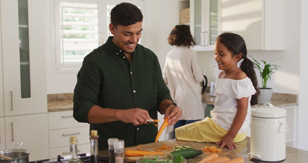 Father Peeling Vegetables with Daughter in Modern Kitchen - Free Images, Stock Photos and Pictures on Pikwizard.com