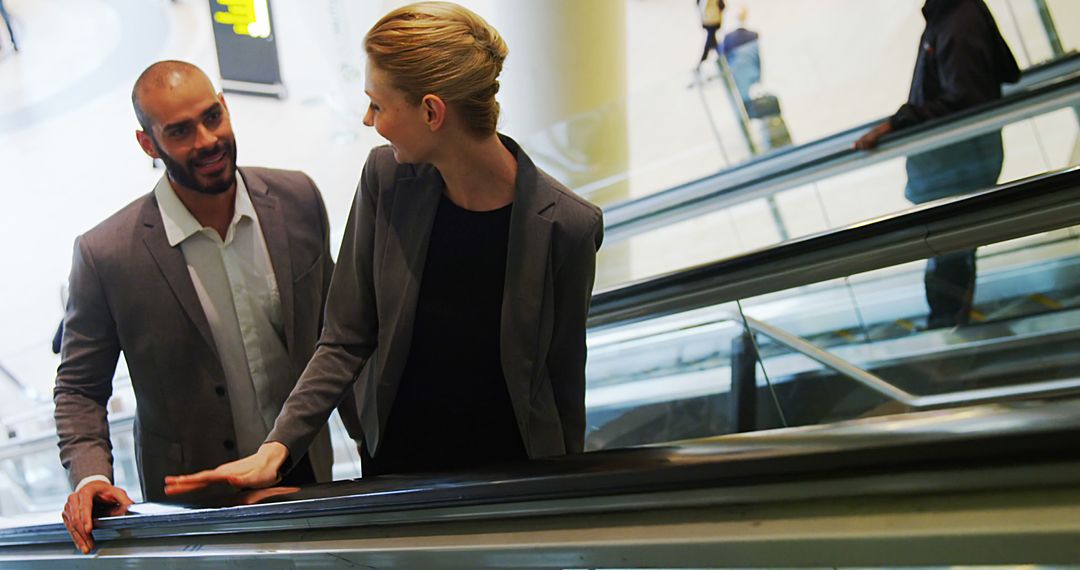 Business Professionals Riding Escalator in Modern Office Building - Free Images, Stock Photos and Pictures on Pikwizard.com