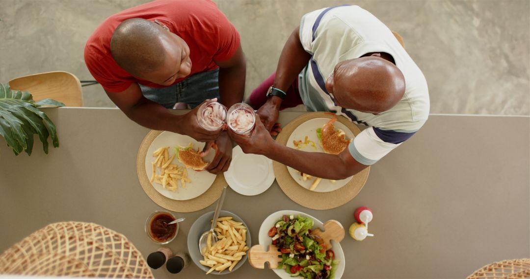 Father and Son Enjoying a Home-Cooked Burger Meal with Friendship