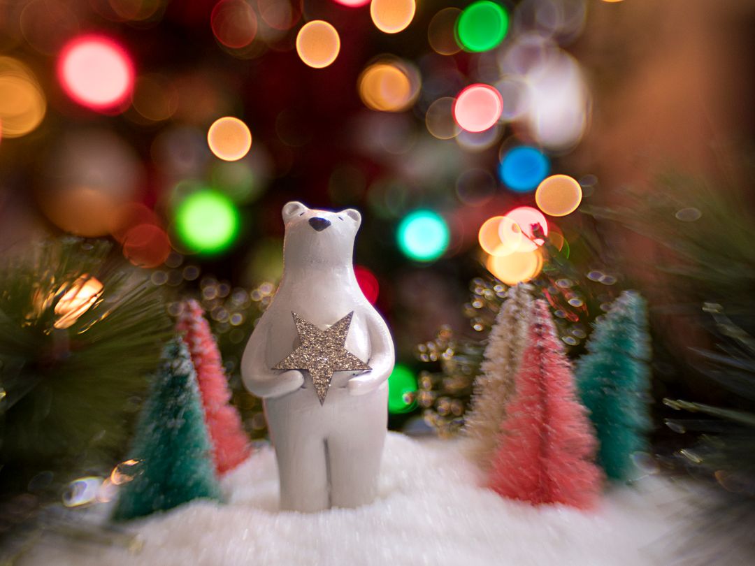 Polar Bear Ornament Surrounded by Colorful Lights and Trees