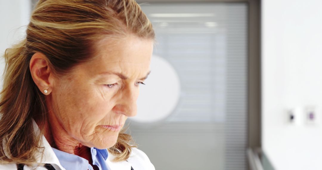 Focused Senior Female Doctor Wearing Stethoscope in Hospital - Free Images, Stock Photos and Pictures on Pikwizard.com