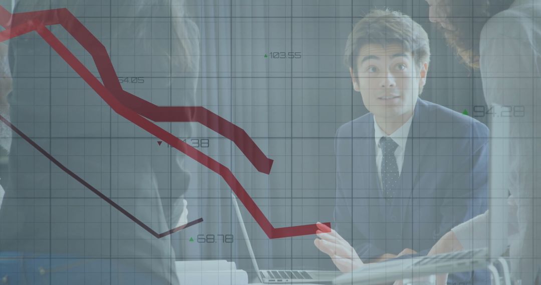 Business Team Analyzing Downward Trend with Financial Graphs