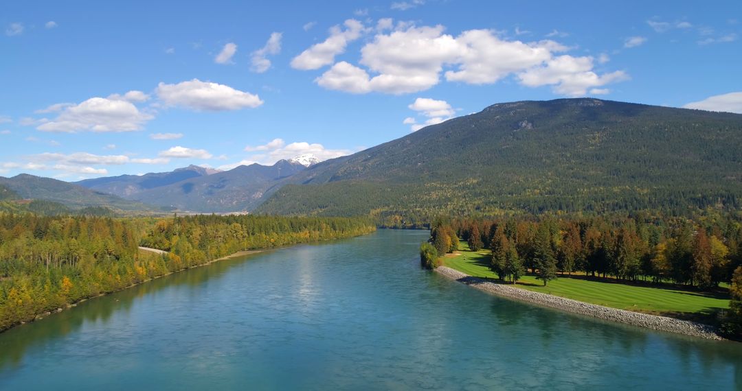 Aerial View of Peaceful River in Mountain Valley on Sunny Day - Free Images, Stock Photos and Pictures on Pikwizard.com