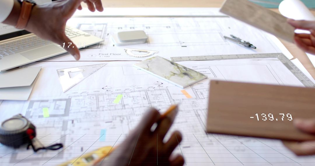 Architects Collaborating on Floor Plan with Blueprints and Samples