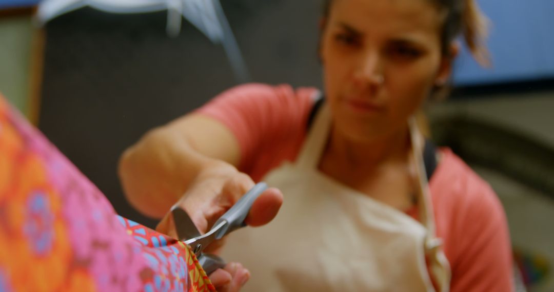 Woman Cutting Colorful Fabric with Scissors - Free Images, Stock Photos and Pictures on Pikwizard.com