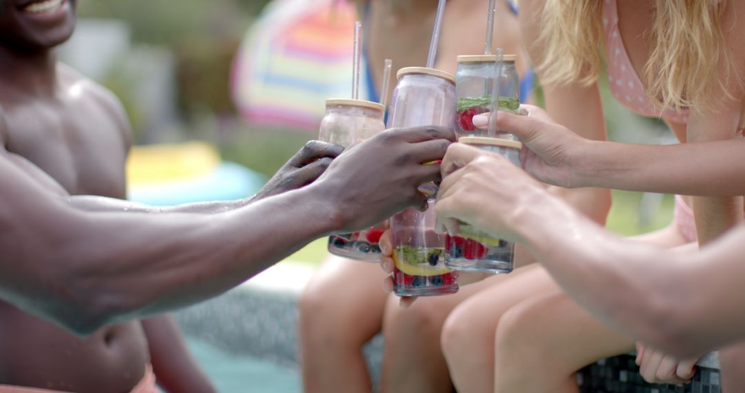 Diverse Group Clinking Fruit-Infused Water at Summer Pool Party