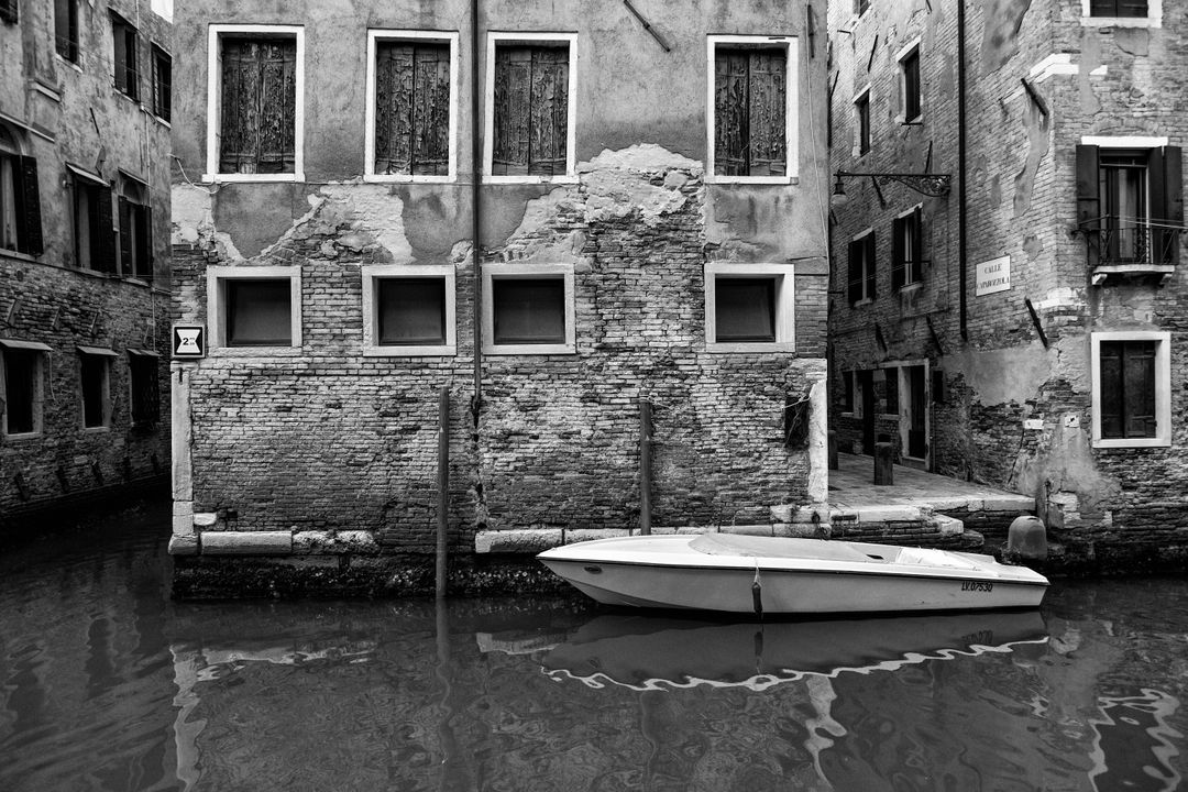 Vintage Canal Scene with Old Brick Buildings and Boat in Black and White - Free Images, Stock Photos and Pictures on Pikwizard.com