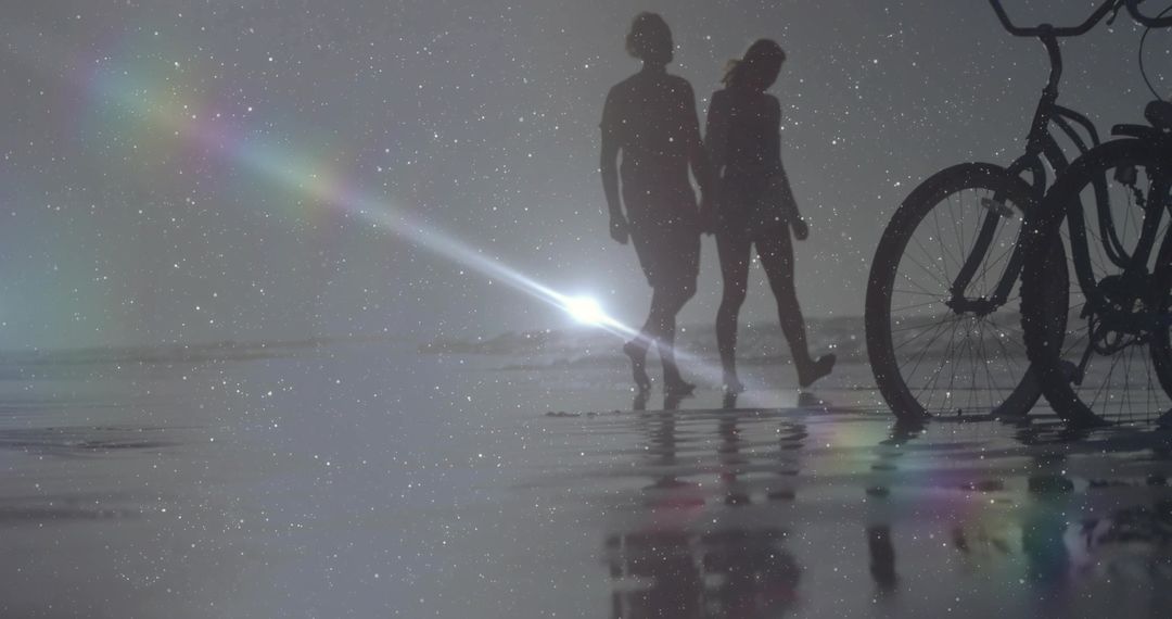 Silhouettes of Couple Walking on Reflective Beach at Twilight with Bicycles