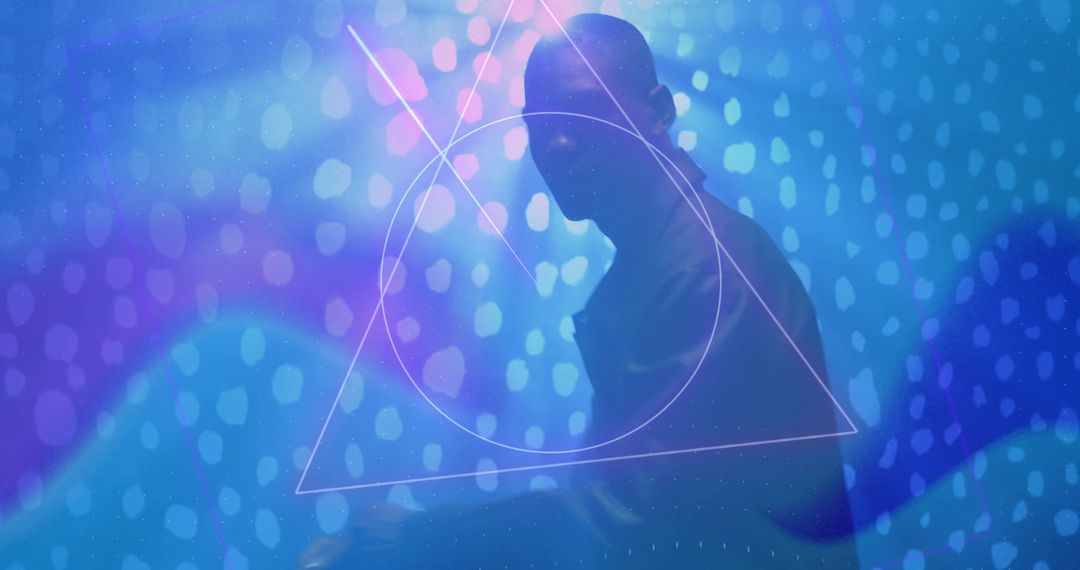 Man Posing on LED Stage with Geometric Lights