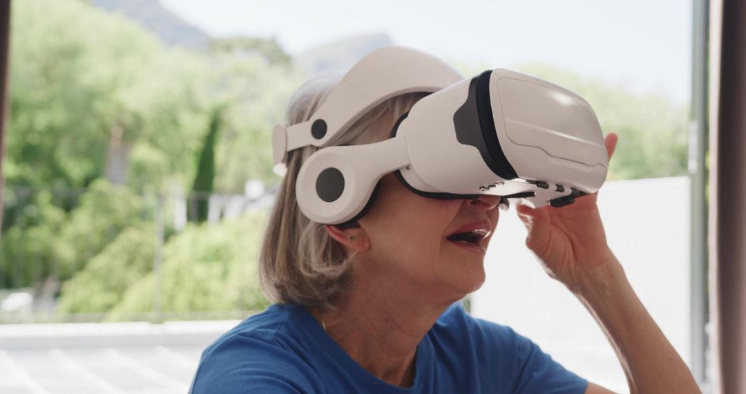 Senior Woman Exploring Virtual Reality Technology at Home
