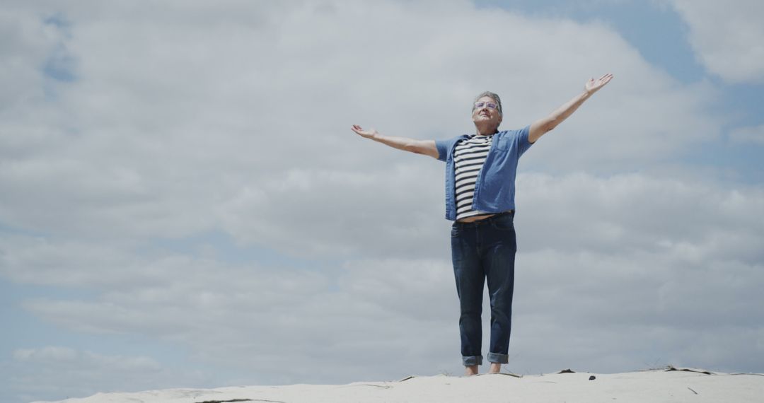 Happy Senior Man Standing on Beach with Open Arms - Free Images, Stock Photos and Pictures on Pikwizard.com