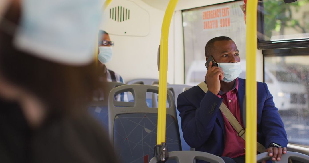 Man Wearing Face Mask on City Bus Using Mobile Phone During Pandemic