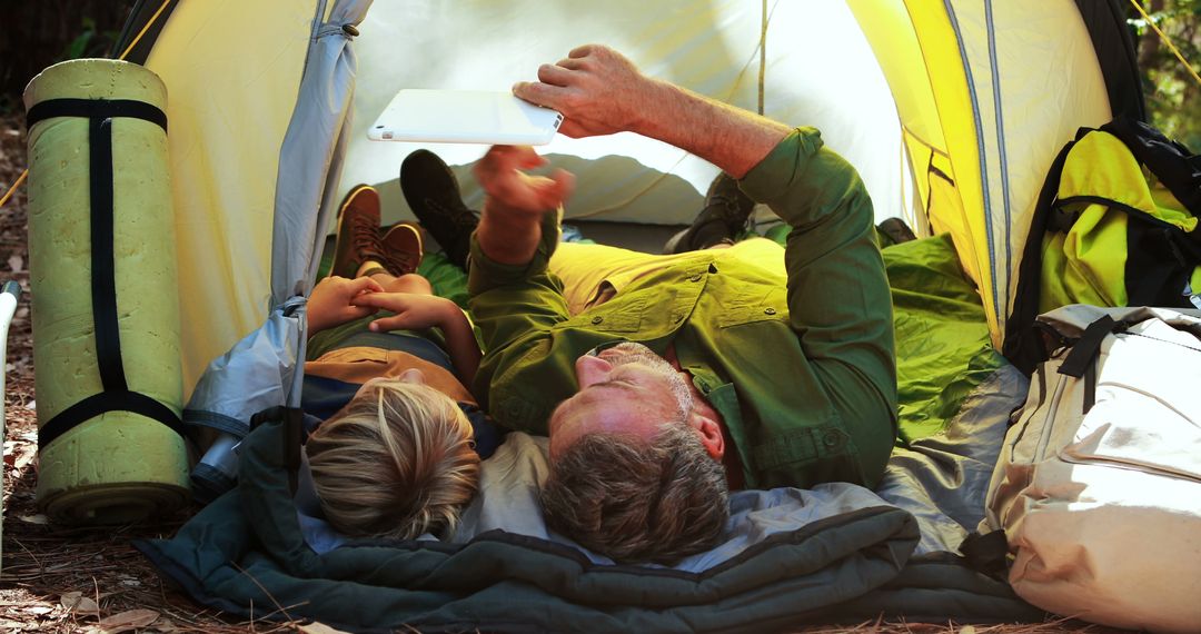 Father and Son Relaxing in a Tent During Hiking Trip - Free Images, Stock Photos and Pictures on Pikwizard.com