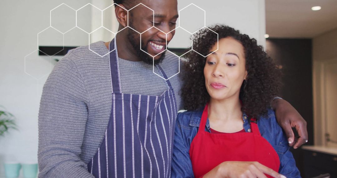 Couple Embracing While Cooking Together in Kitchen